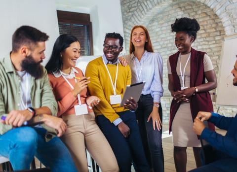 diverse group of individuals sitting and smiling