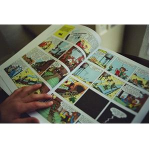 hand holding open comic book