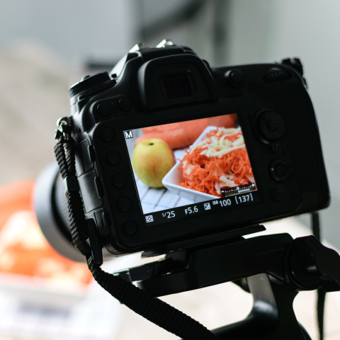 the viewer side of a digital camera shows that the camera is focused on a display of food on a table