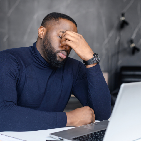man with hand on face looking frustrated