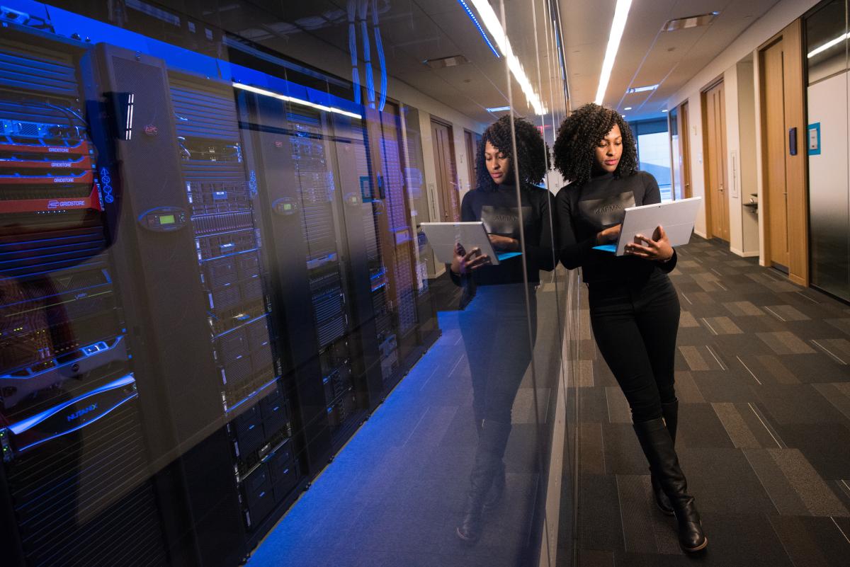 woman leaning against window of server room