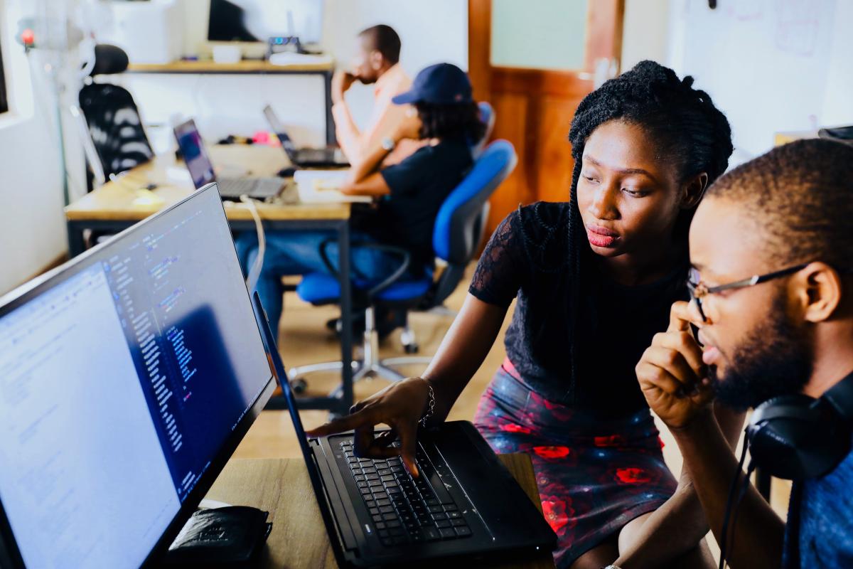 adults working together at computer