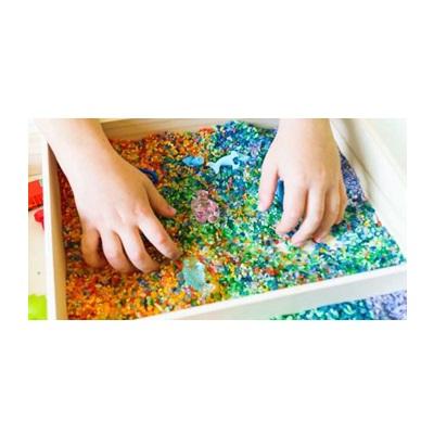 child's hands in sensory box