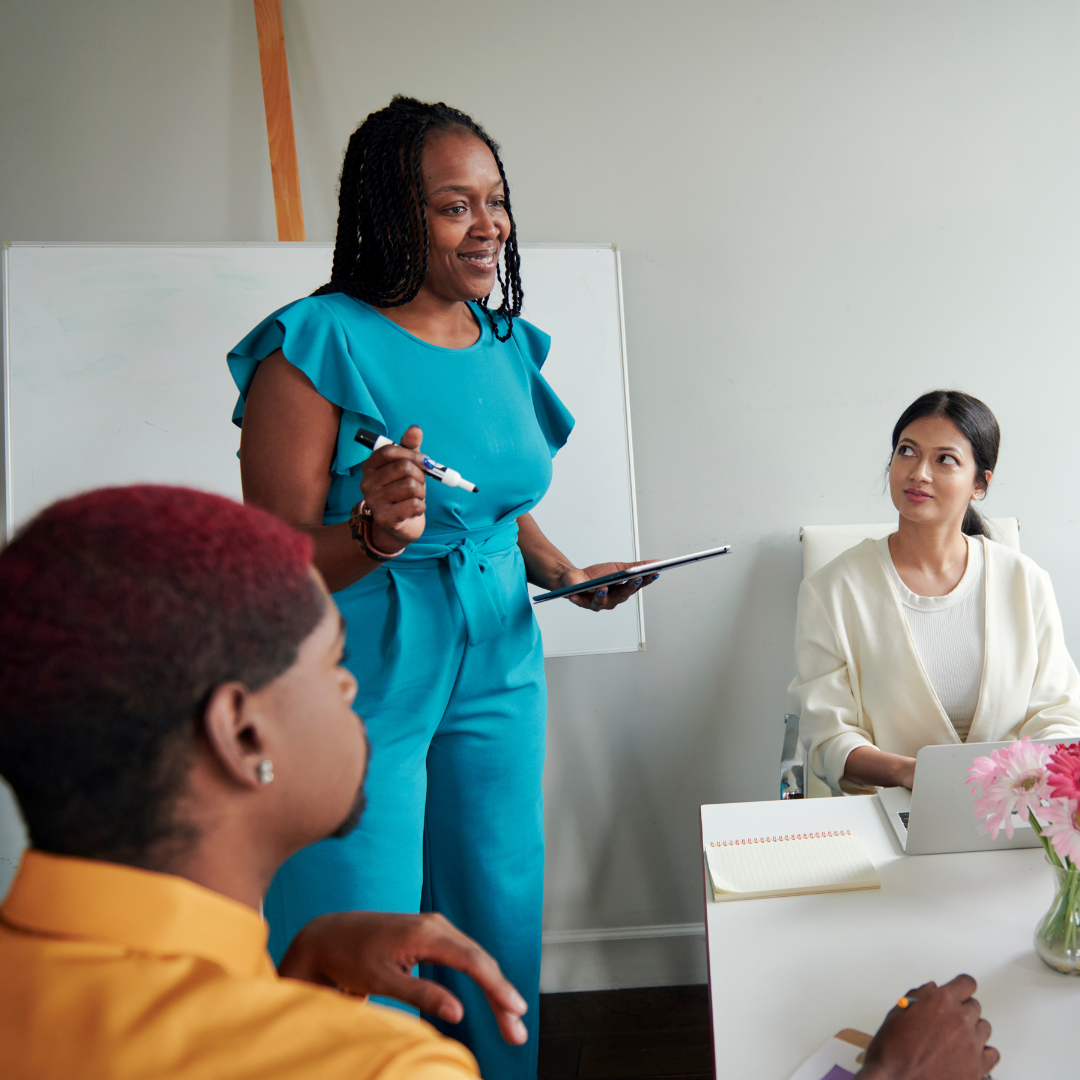 woman standing at table leading meeting