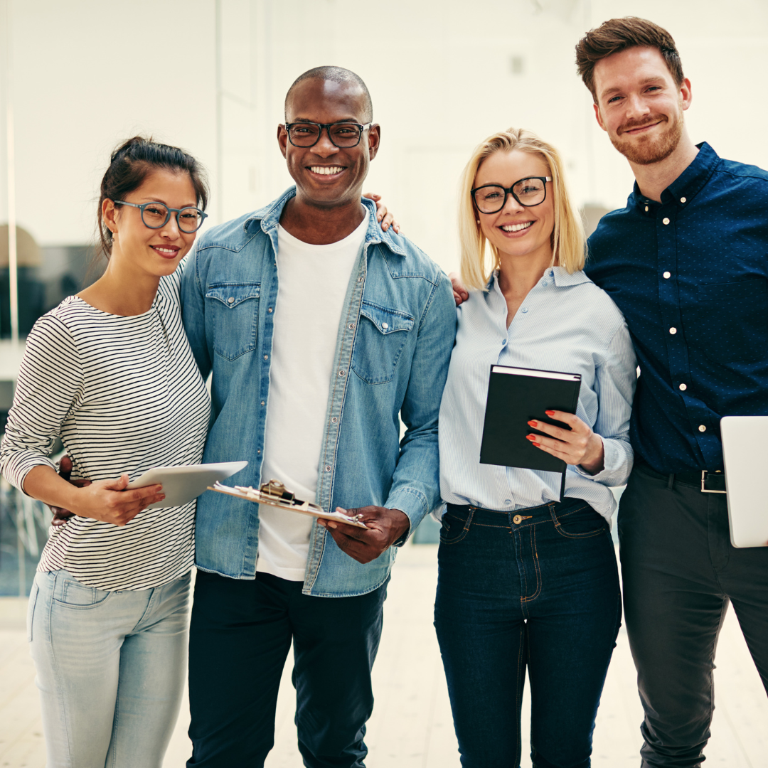 four adults standing together smiling