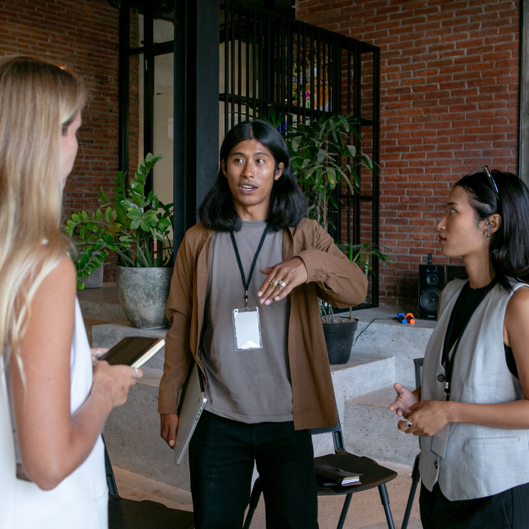 3 staff members speaking to each other
