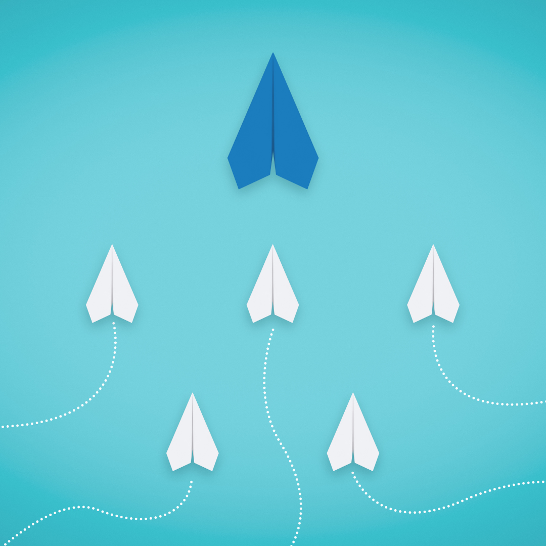 blue paper airplane being followed by smaller white paper airplanes