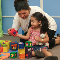mother and daughter playing with toy blocks